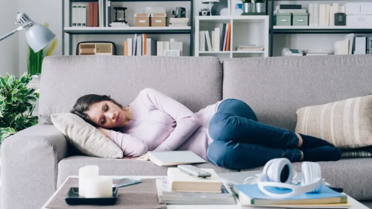 pregnant woman in her first trimester sleeping on the couch, not doing anything