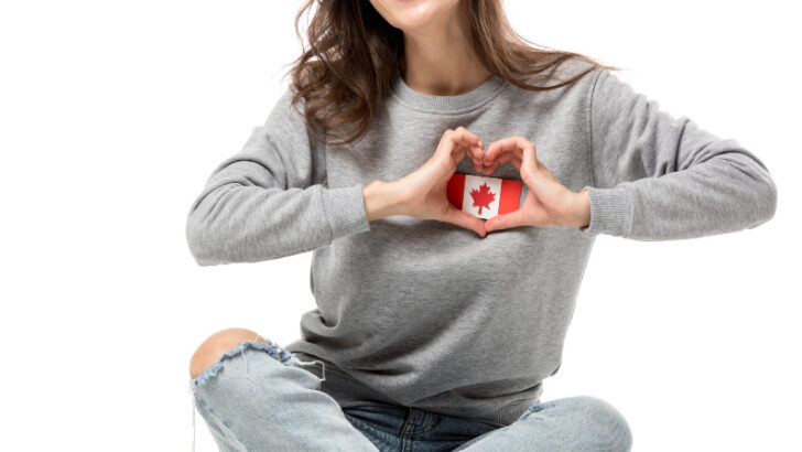 woman holding mini canadian flag over her heart
