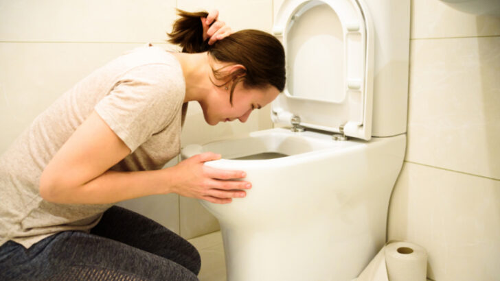 pregnant woman throwing up in toilet