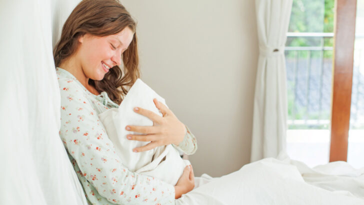 someone who just had a baby, holding her newborn