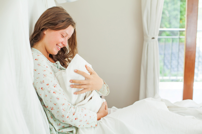 someone who just had a baby, holding her newborn