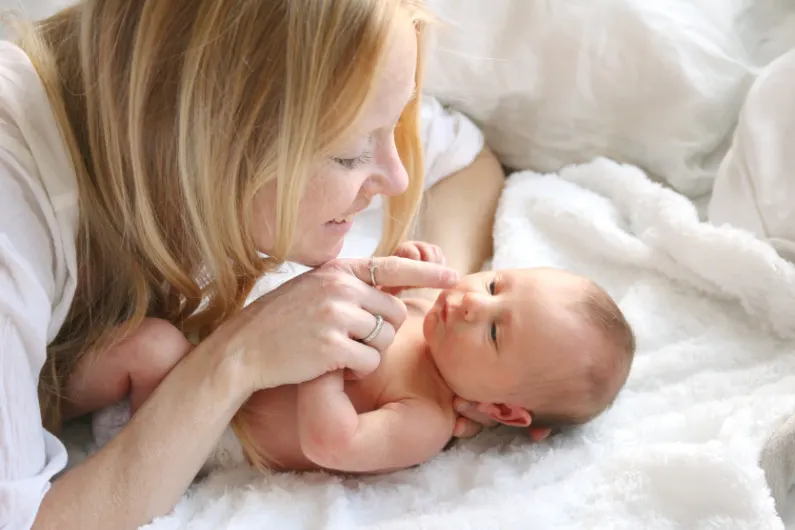 happy mom who stopped breastfeeding, enjoying her baby