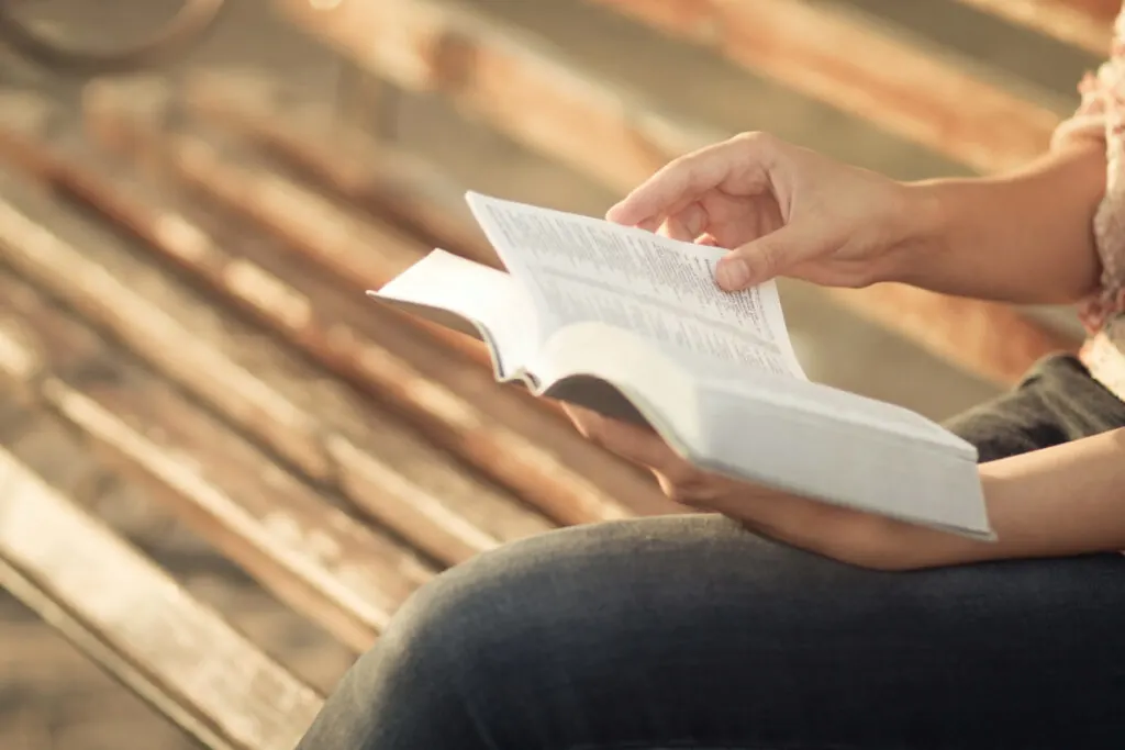 pregnant mom reading the Bible, looking for two syllable bible boy names