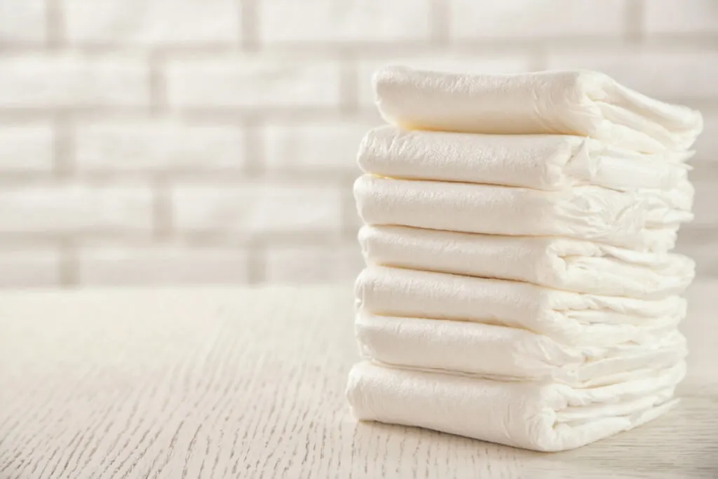 diapers stacked neatly on clear countertop