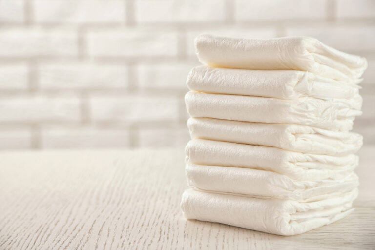 diapers stacked neatly on clear countertop