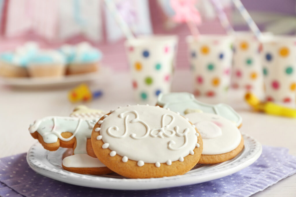 cookies decorated with white frosting and the word "baby"