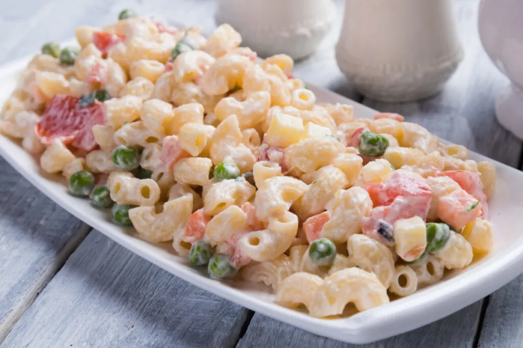 homemade creamy macaroni salad on white serving platter