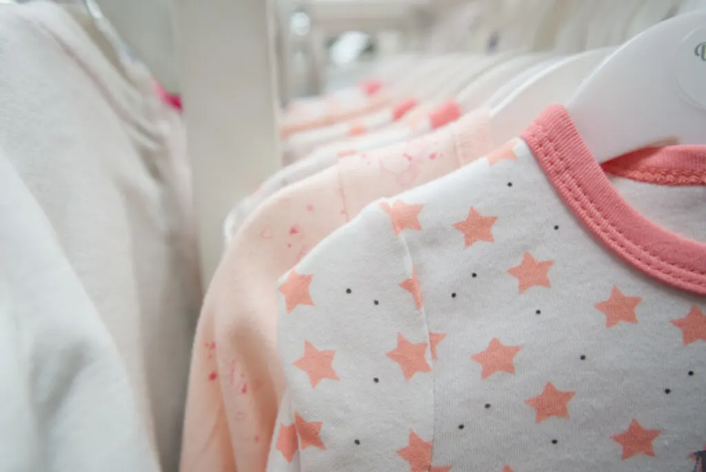 baby clothes on hangers in closet