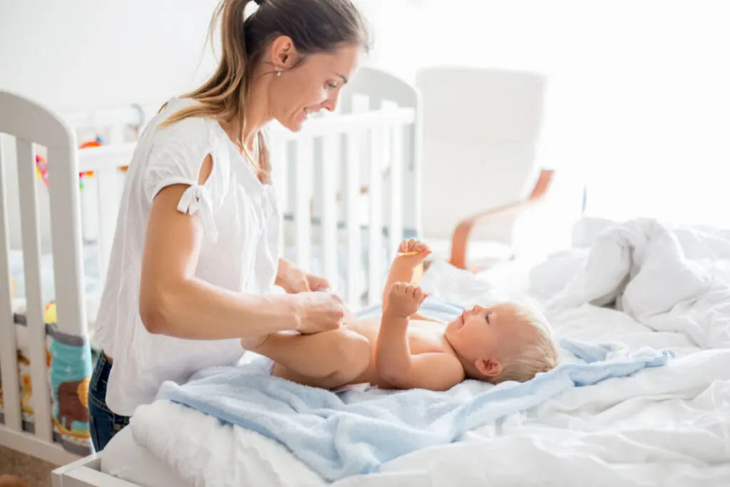 mom changing cloth diaper after baby bath