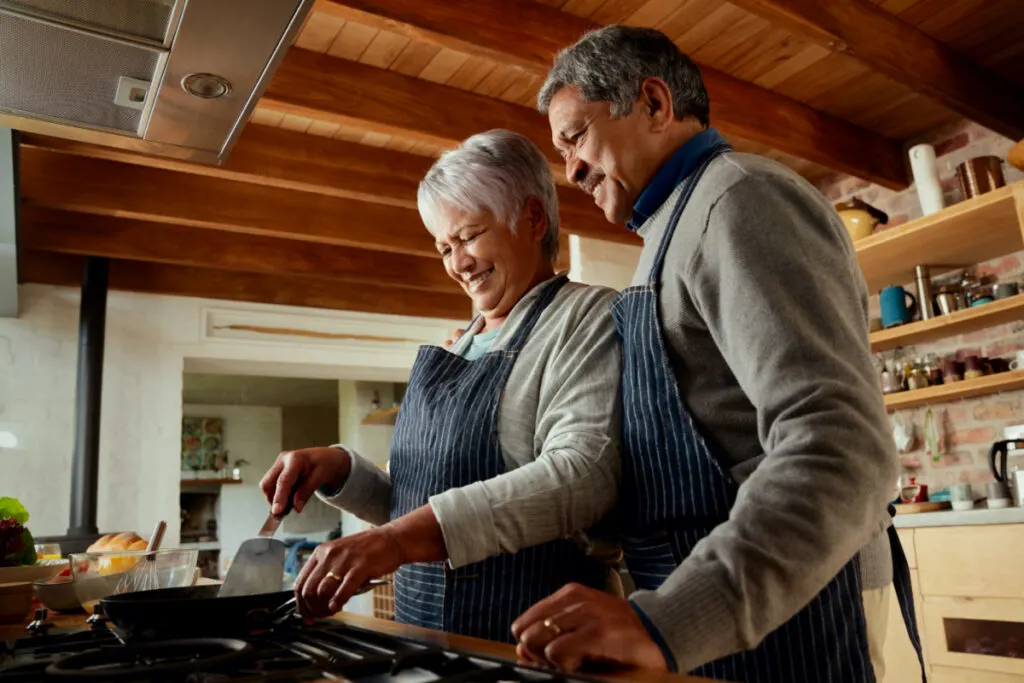 grandparents cooking together in kitchen