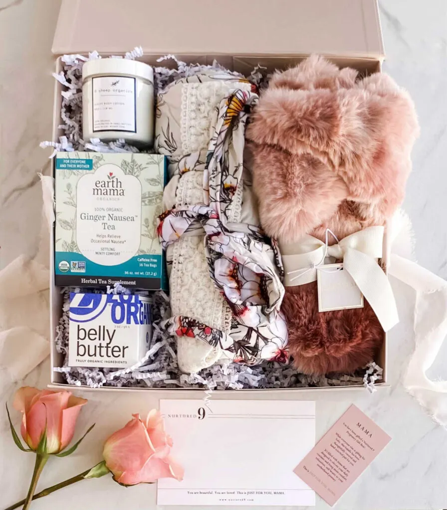 nurtured nine pregnancy gift box open to display contents, including ginger nausea tea, belly butter and a robe