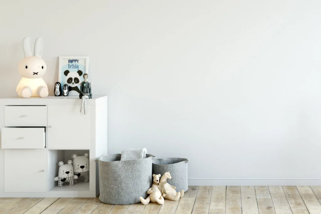 four cube white organizer in baby nursery with baskets and stuffed animals