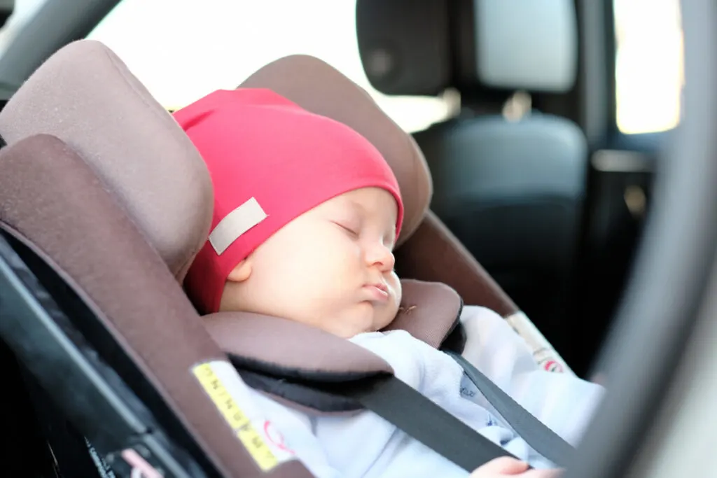 baby finally stops crying and falls asleep in their car seat.