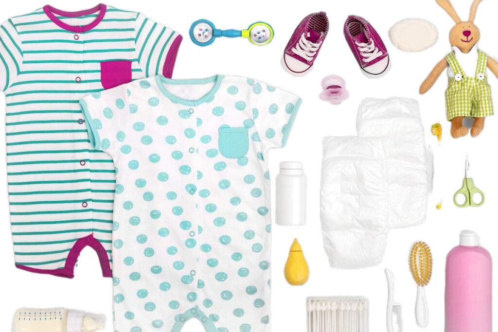 infant travel essentials, such as clothes, diapers and nail clippers, on white background.