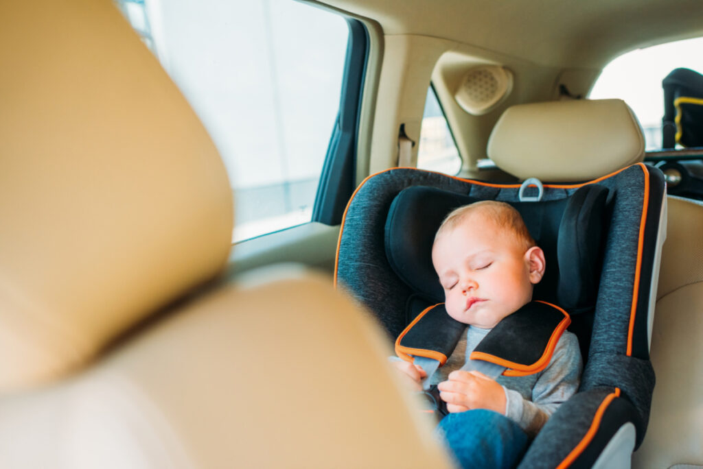 baby asleep during long car ride in front facing car seat 