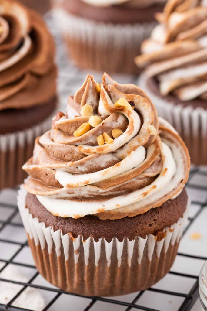 nutella cupcakes with Nutella buttercream frosting and chopped hazelnuts.