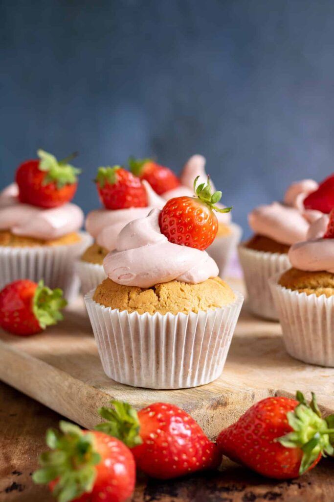 peanut butter and jelly cupcakes with fresh strawberries on top.