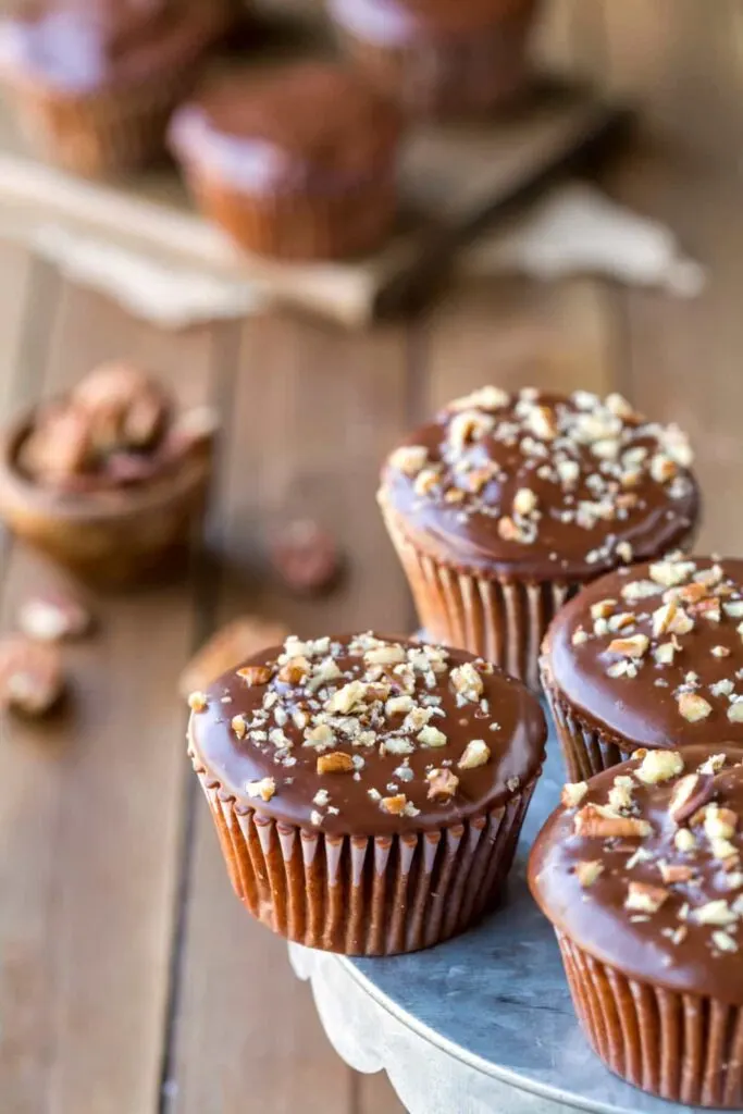 Texas sheet cake cupcakes topped with chopped pecans.