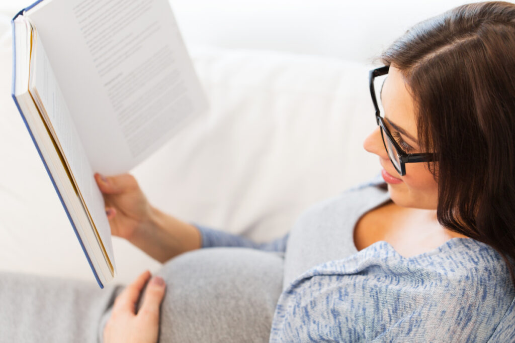 pregnant woman reading about what to expect during labor