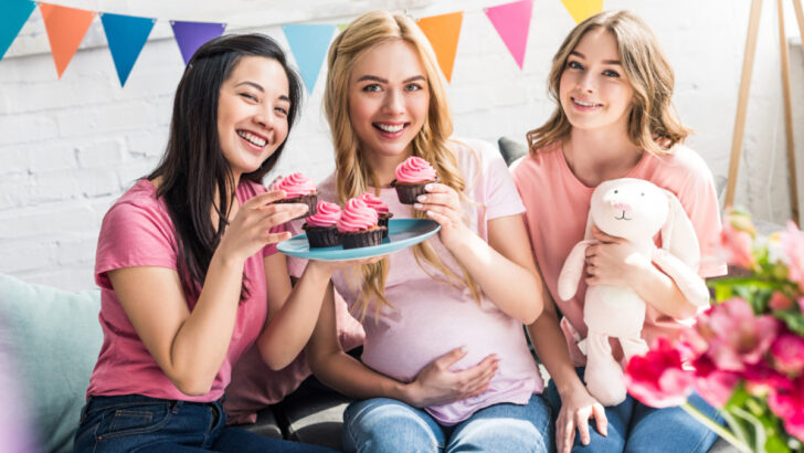 friends with the mom-to-be eating cupcakes at baby shower