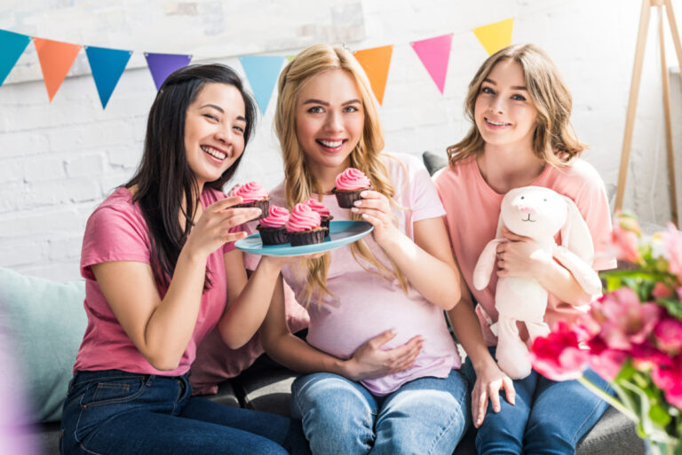 friends with the mom-to-be eating cupcakes at baby shower