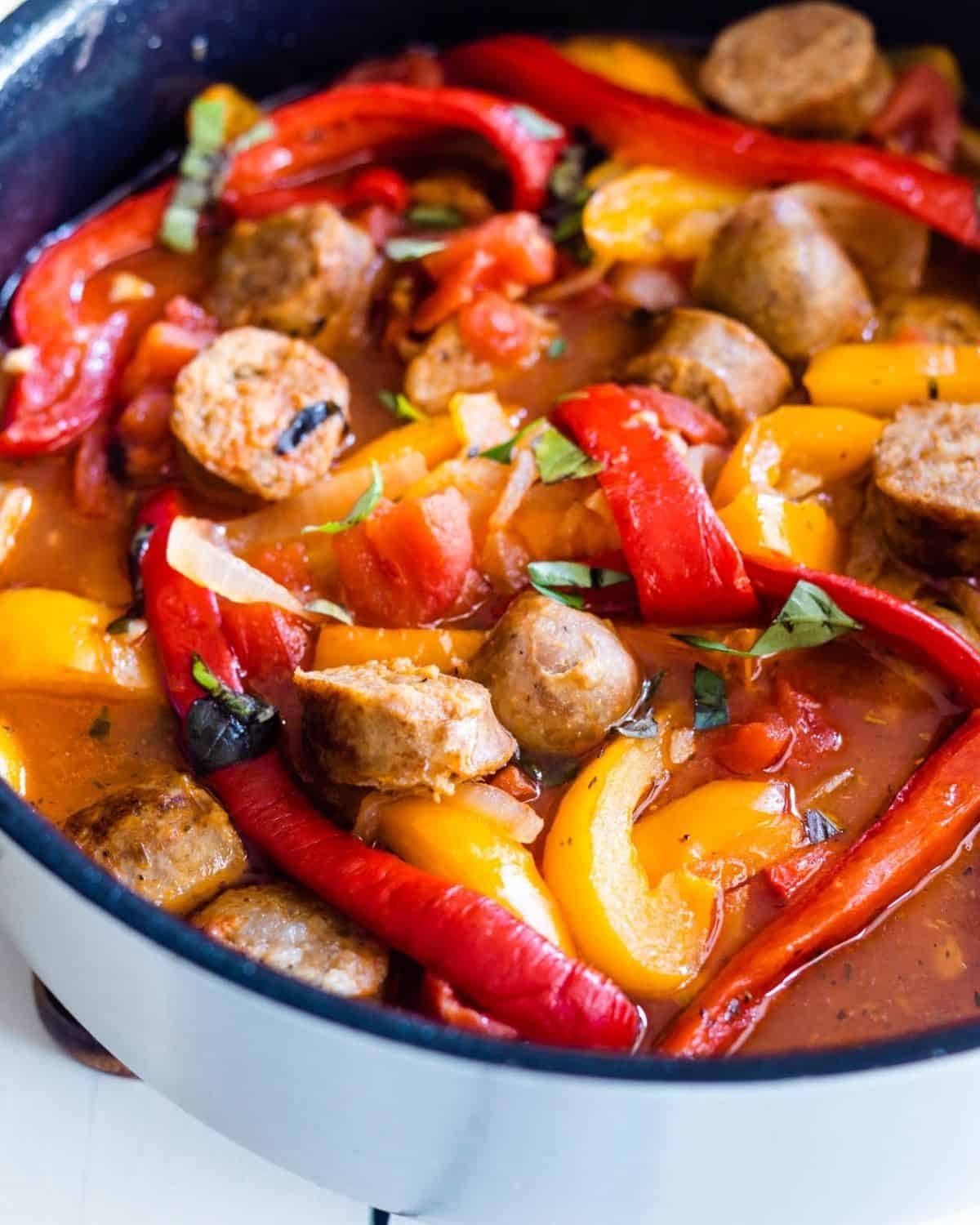Italian sausage and peppers in saucepan.