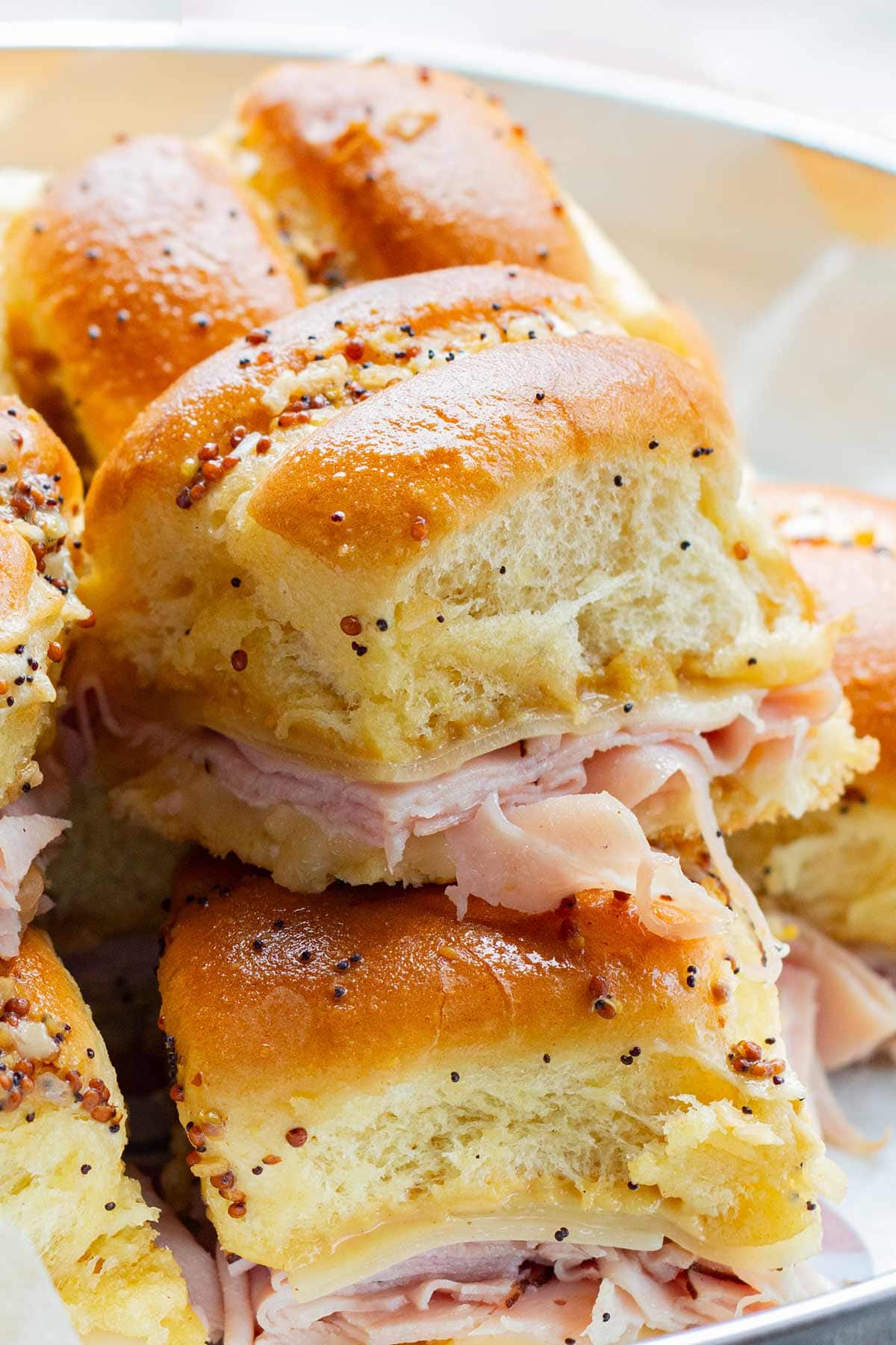 ham and cheese sliders with poppy seeds and dried minced onions.