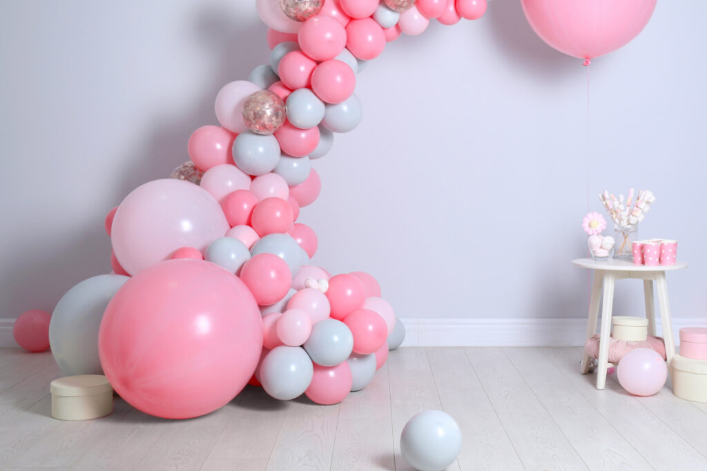 balloon arch with pink and blue and gray balloons for budget baby shower.
