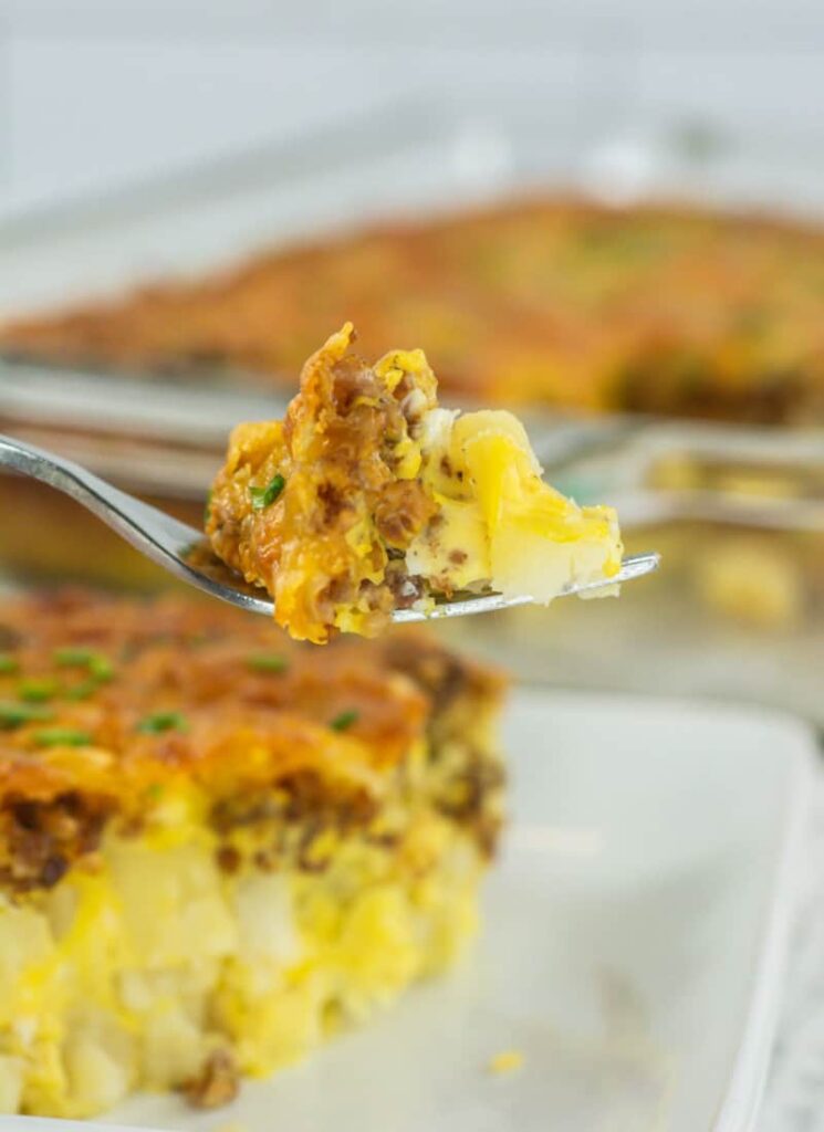 bite of breakfast casserole on fork close-up.