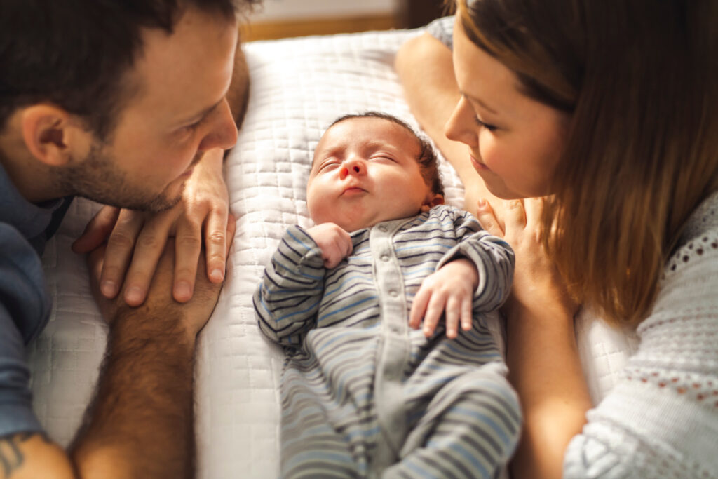 new parents with newborn between them, waiting for meals from meal train.