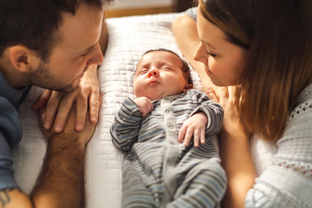 new parents with newborn between them, waiting for meals from meal train.