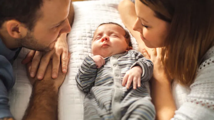 new parents with newborn between them, waiting for meals from meal train.