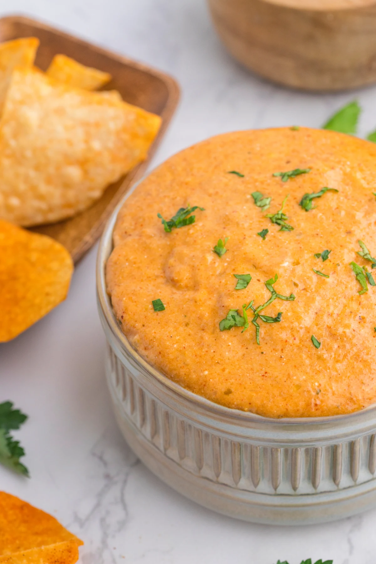 cottage cheese queso dip appetizer in white ramekin on white marble countertop.