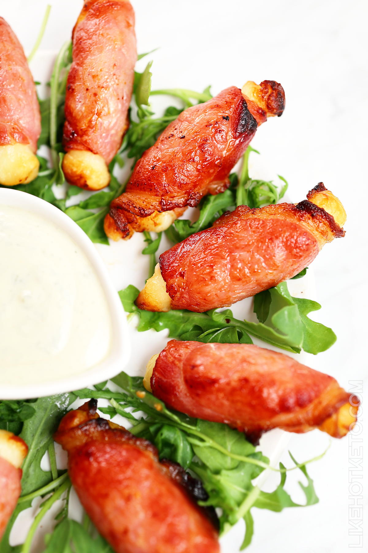 bacon wrapped halloumi on lettuce.