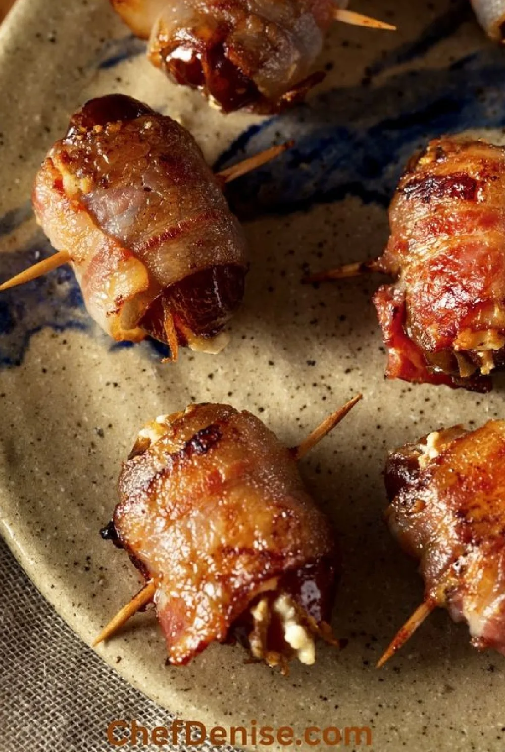 bacon-wrapped stuffed dates on a platter.
