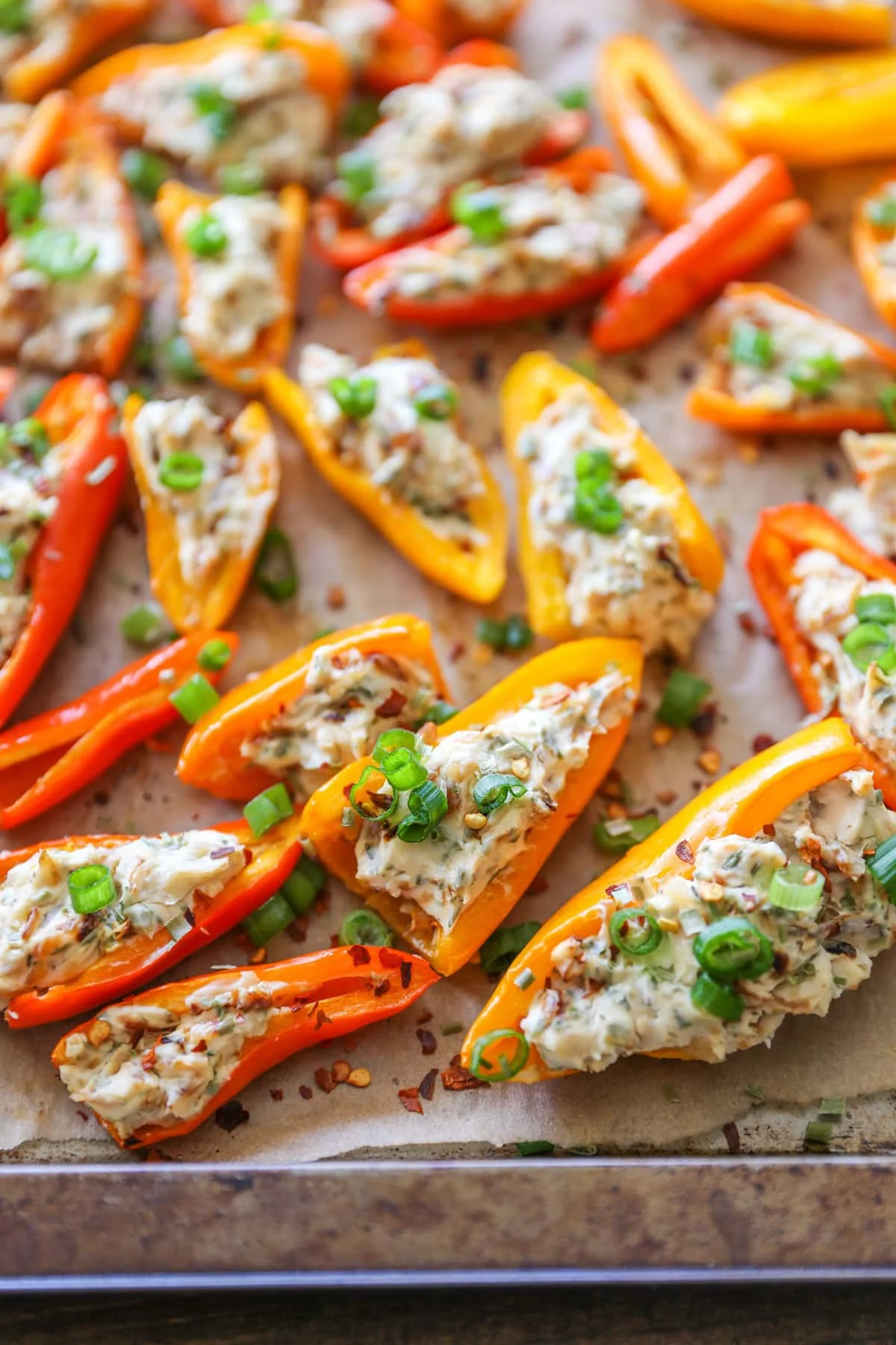 cream cheese stuffed peppers on parchment paper.