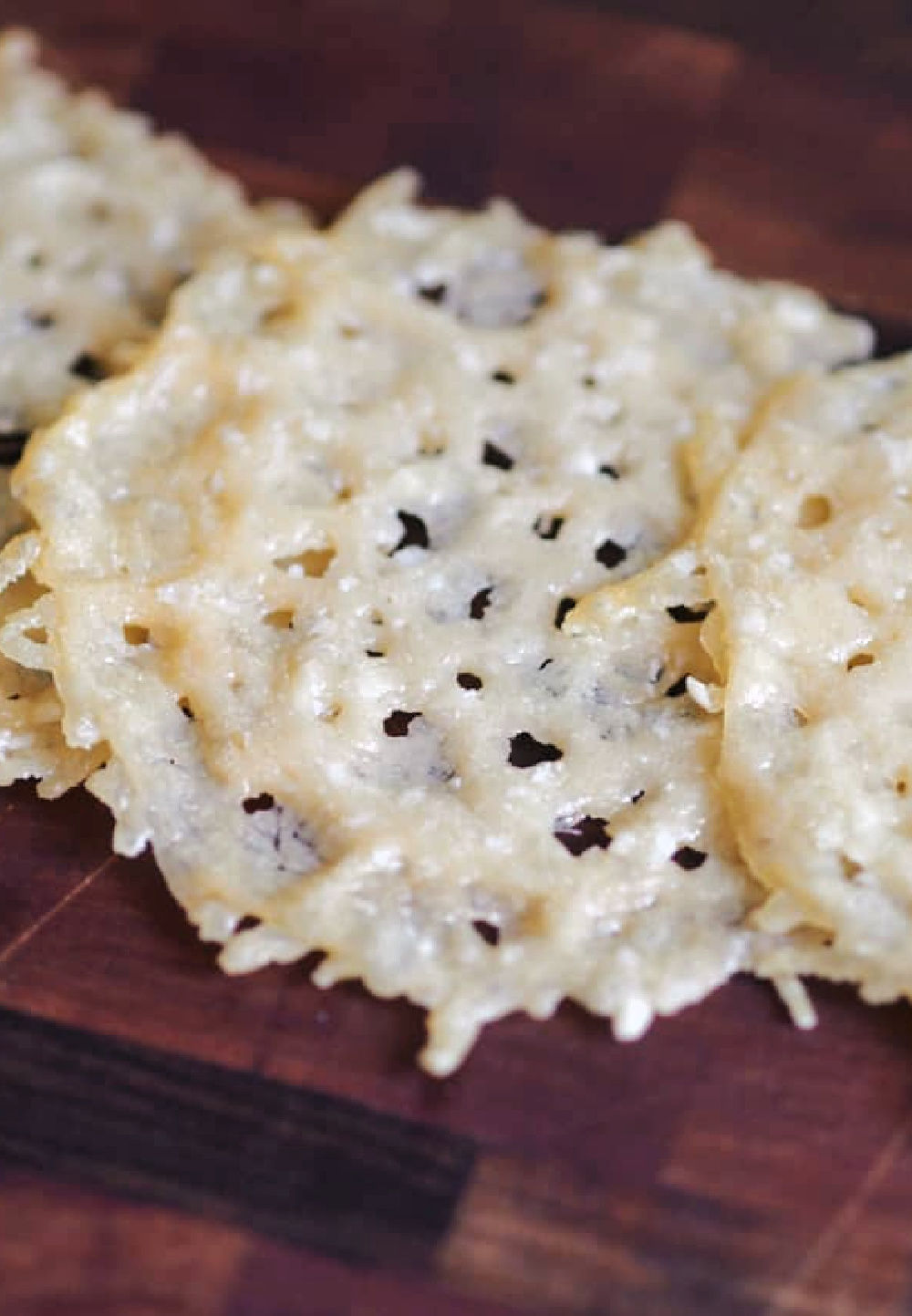 parmesan crisps in focus on table.